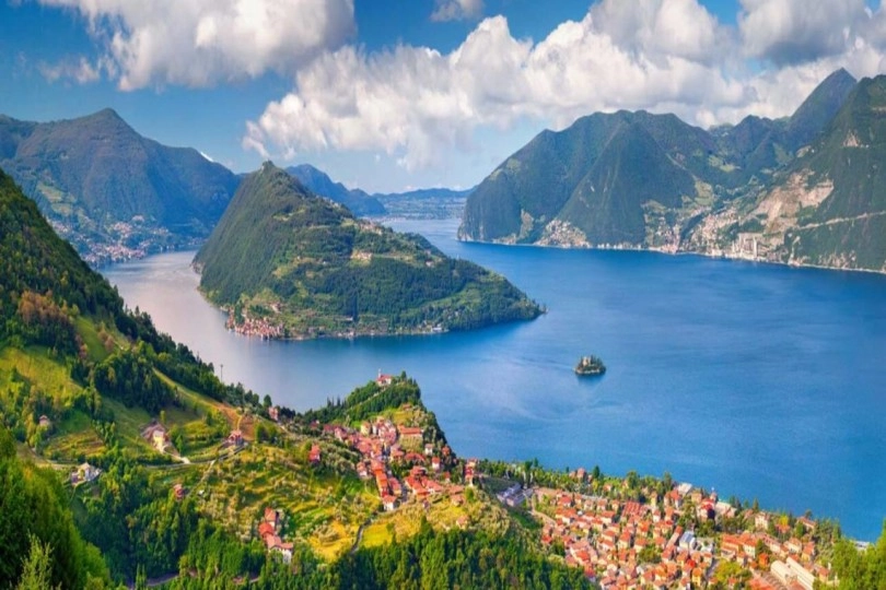 Aerial view of Lake Iseo with green mountains and a lakeside village