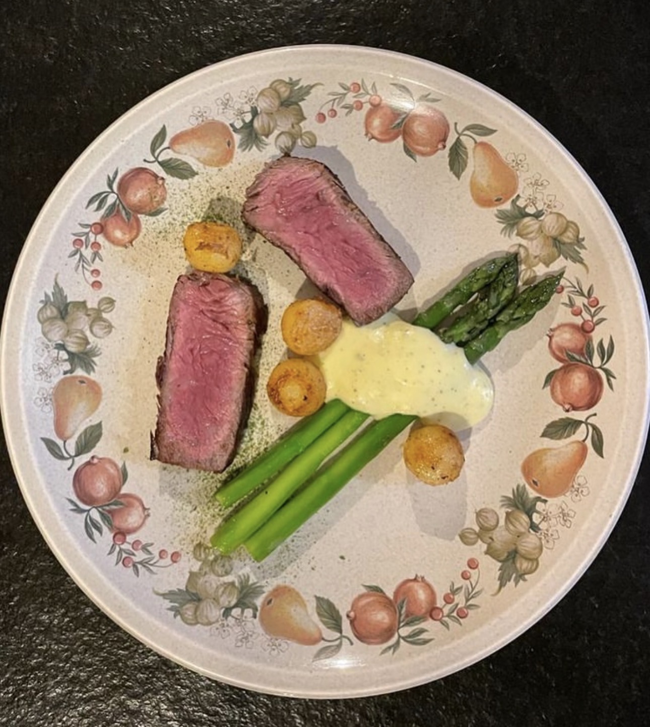 Plated steak with asparagus and potatoes served at the villa