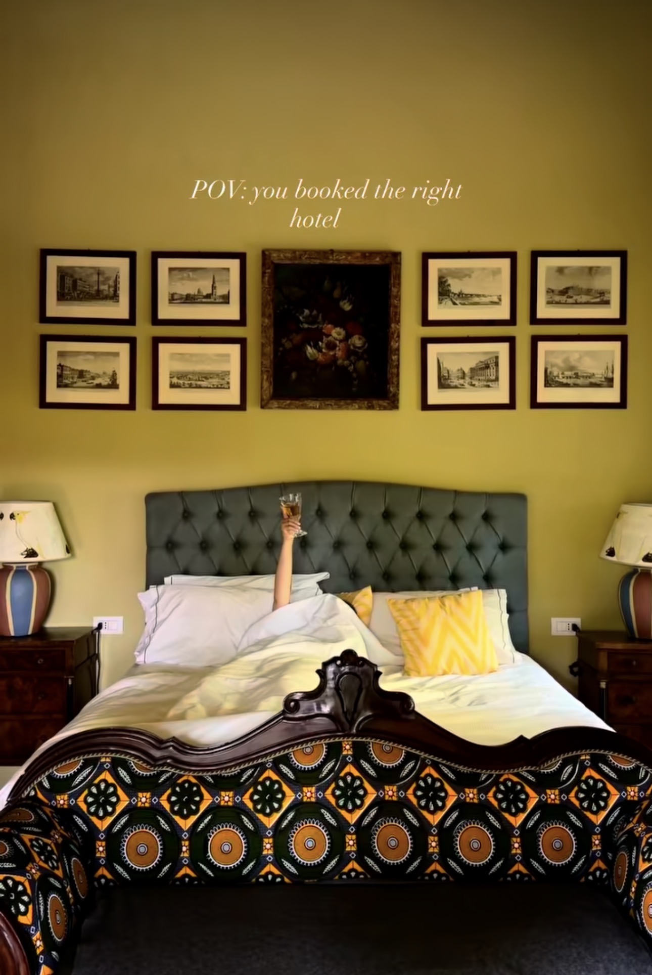 Olive-green guest room with a tufted headboard and a gallery wall of etchings